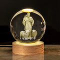 White crystal ball ornament with solid wood warm light base on desk surface