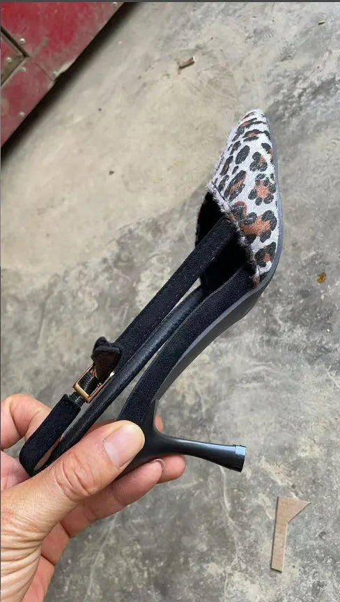 Women's leopard print suede pointed toe high heel sandals on a white background.