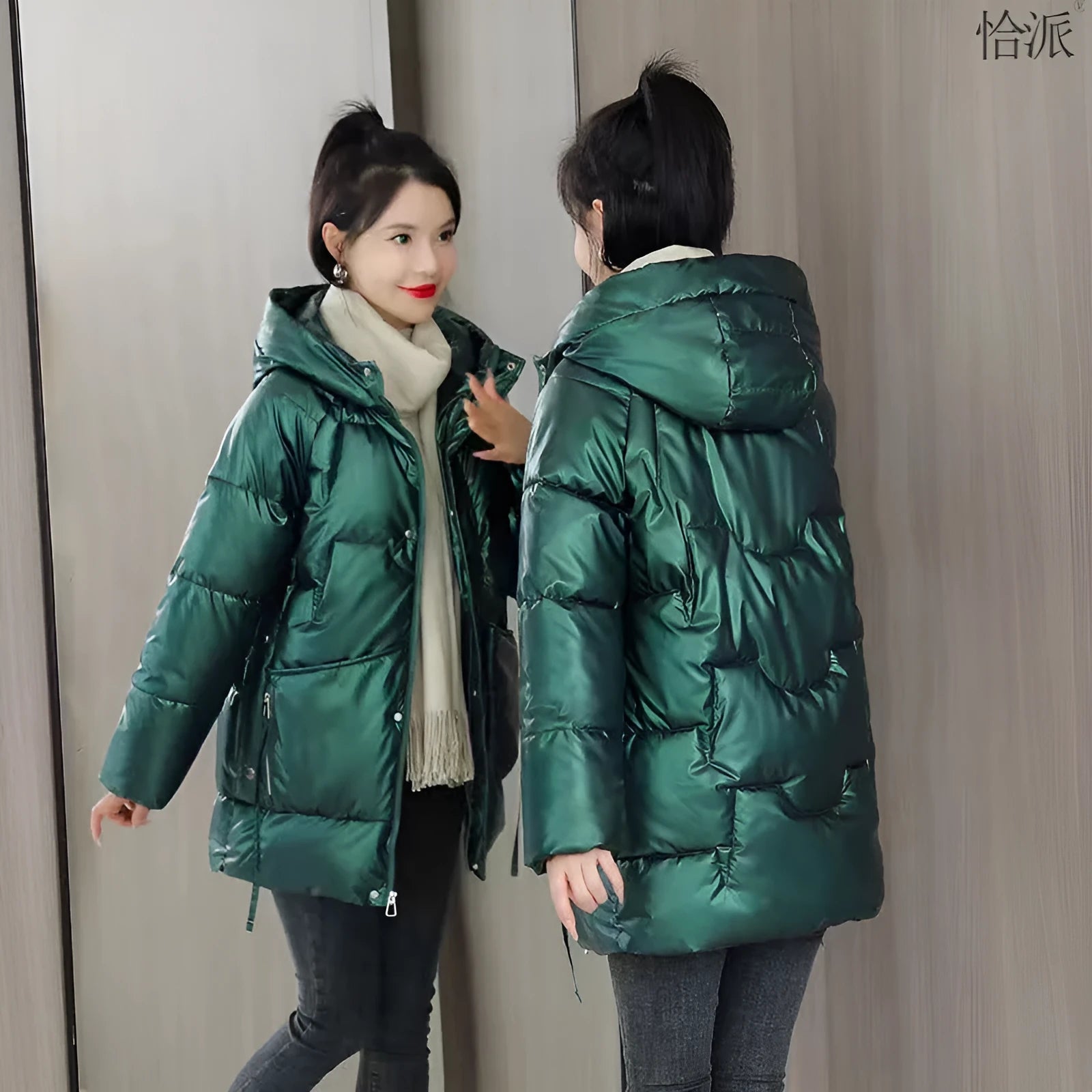 A woman wearing a loose-fit black hooded winter jacket, showcasing its long sleeves and thick construction.