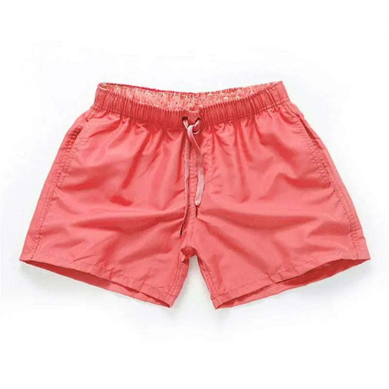 Man wearing soft polyester beach shorts in a straight-leg style, available in multiple colours and plus sizes.