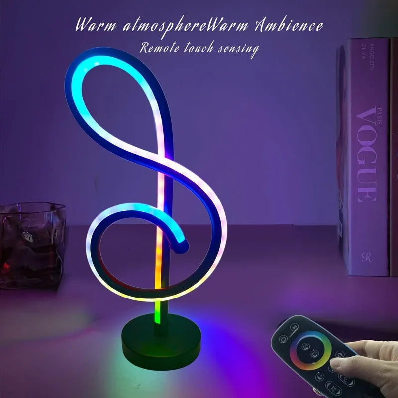 Black musical note shaped Bluetooth LED lamp with RGB colour changing lights on a table.