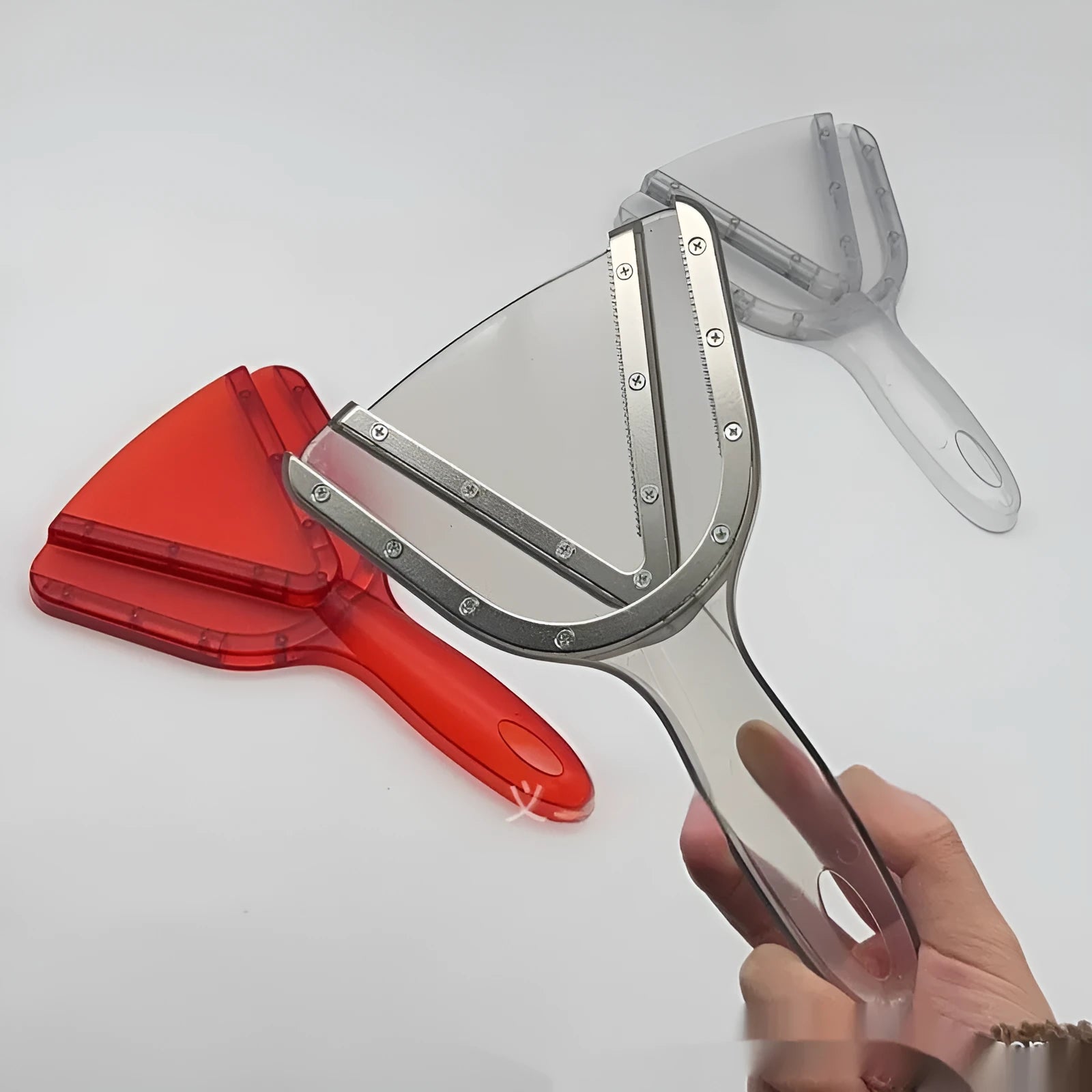 Telescopic red plastic can and bottle opener with adjustable length handle on a kitchen worktop.