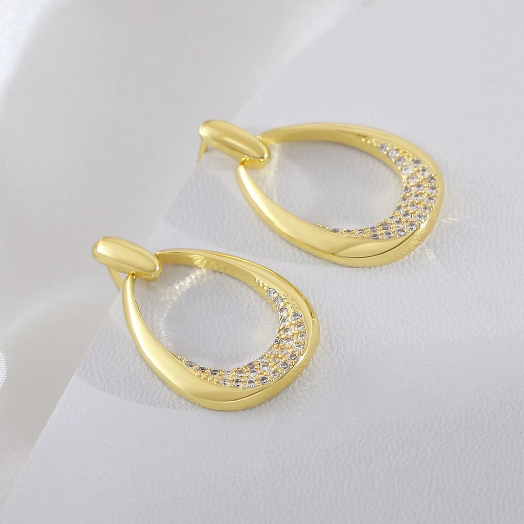 Yellow gold geometric drop earrings with zircon detailing measuring 2.6 by 1.7 centimetres