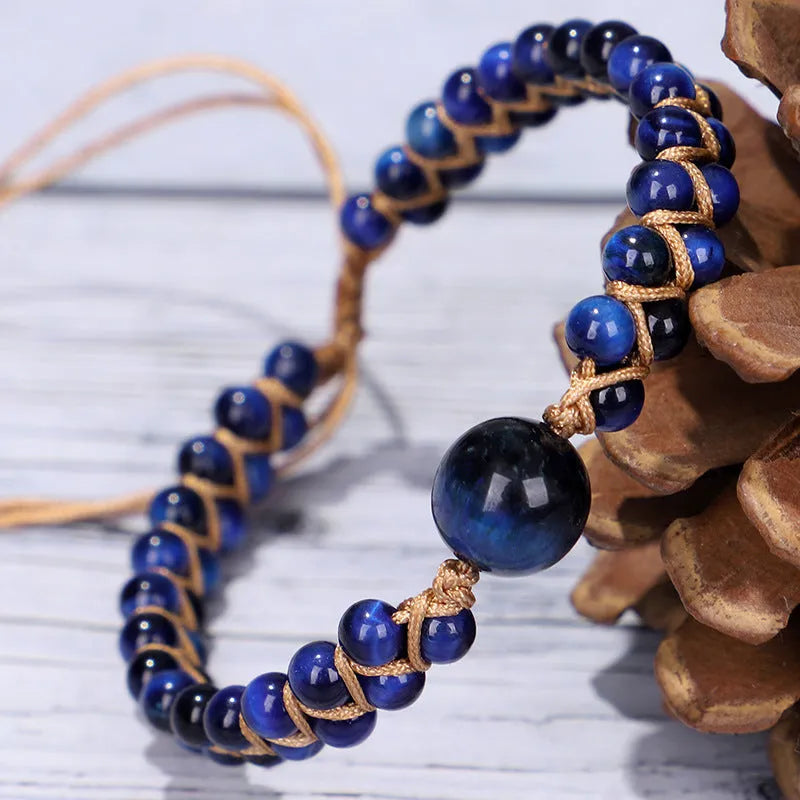 Handmade woven geometric bracelet with blue Tigereye beads and an adjustable pull fastening.