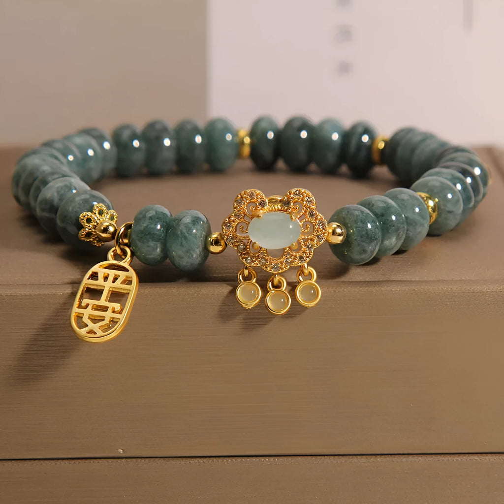 Natural emerald jade abacus bead safety lock style bracelet on women's wrist, alloy frame, green gemstone beads