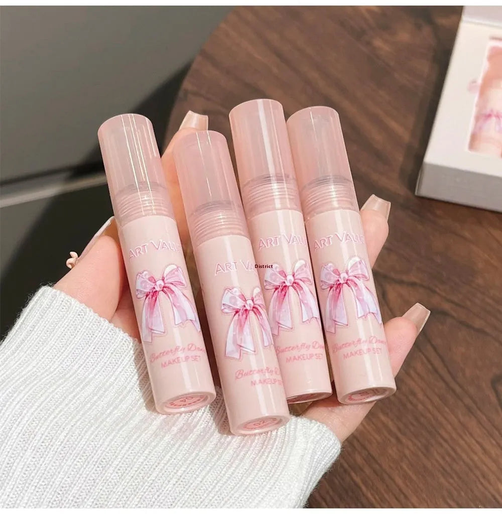 Butterfly Box makeup set showing four pink matte lip muds, powder blusher, and necklace