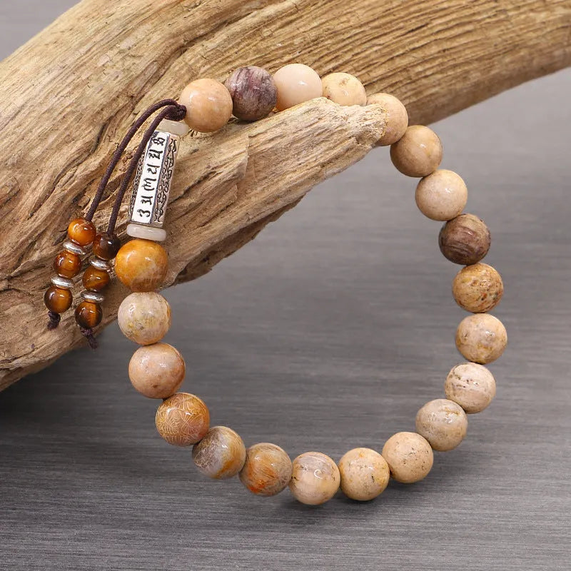 Handmade wood-colour stone bracelet with retro design on a wrist.