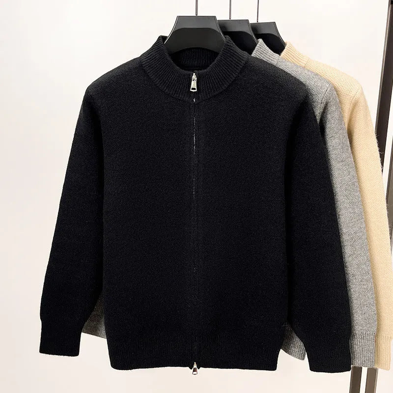 Men's black zip-up knitted cardigan with a stand collar, shown on a model.