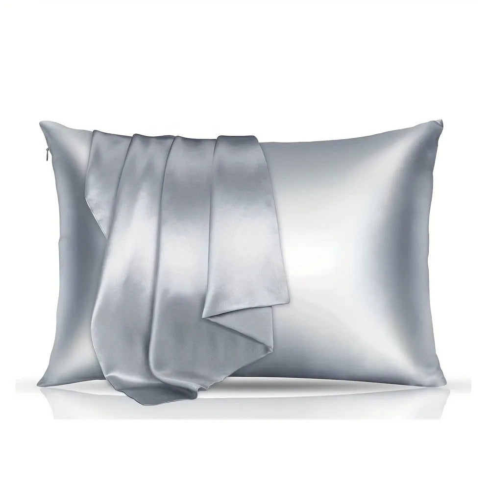 A pair of solid colour satin cloth pillowcases in wine red, shown folded to display their size and smooth texture.