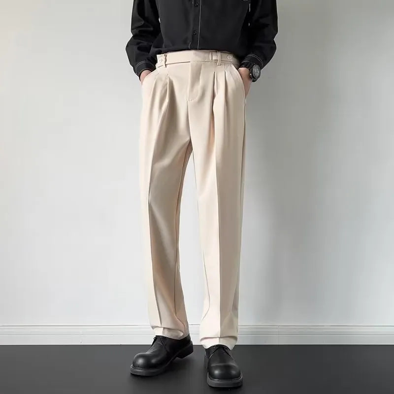 Men's apricot and black straight-leg suit trousers with a loose fit on a hanger.