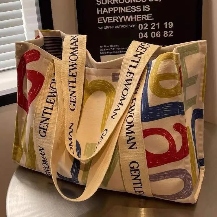 Canvas women's travel tote shopping bag with printed design in unisex style
