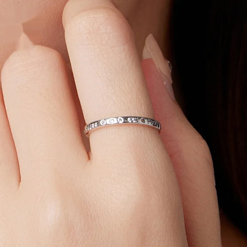 Black oxidised alloy ring with engraved 'I Love You' text, shown on a finger.