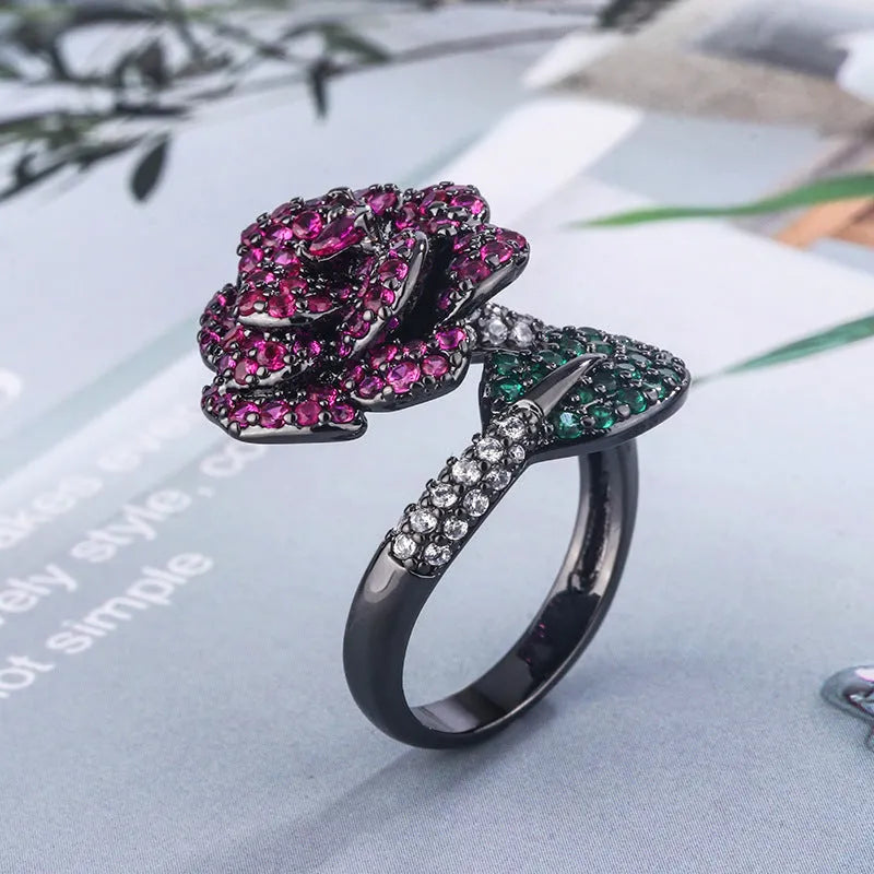 Women's black gold-plated geometric ring with red simulated corundum stones on a copper base.