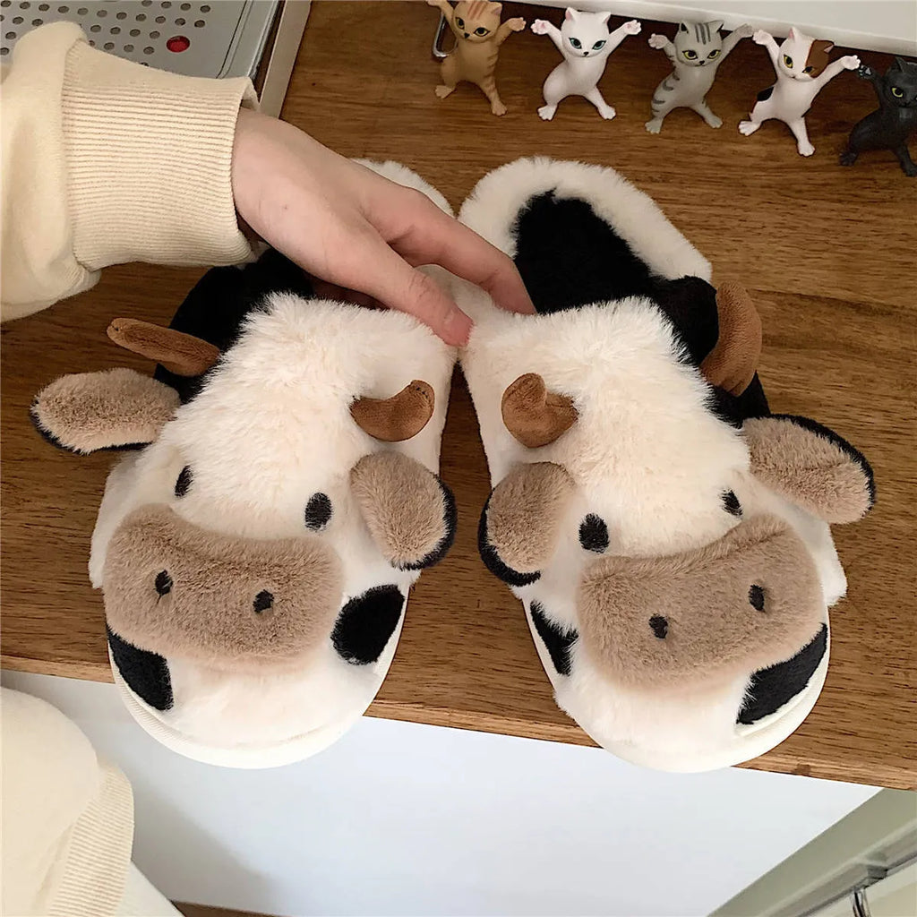 White cartoon cow slippers for women with fluffy faux fur and a textured non-slip sole.