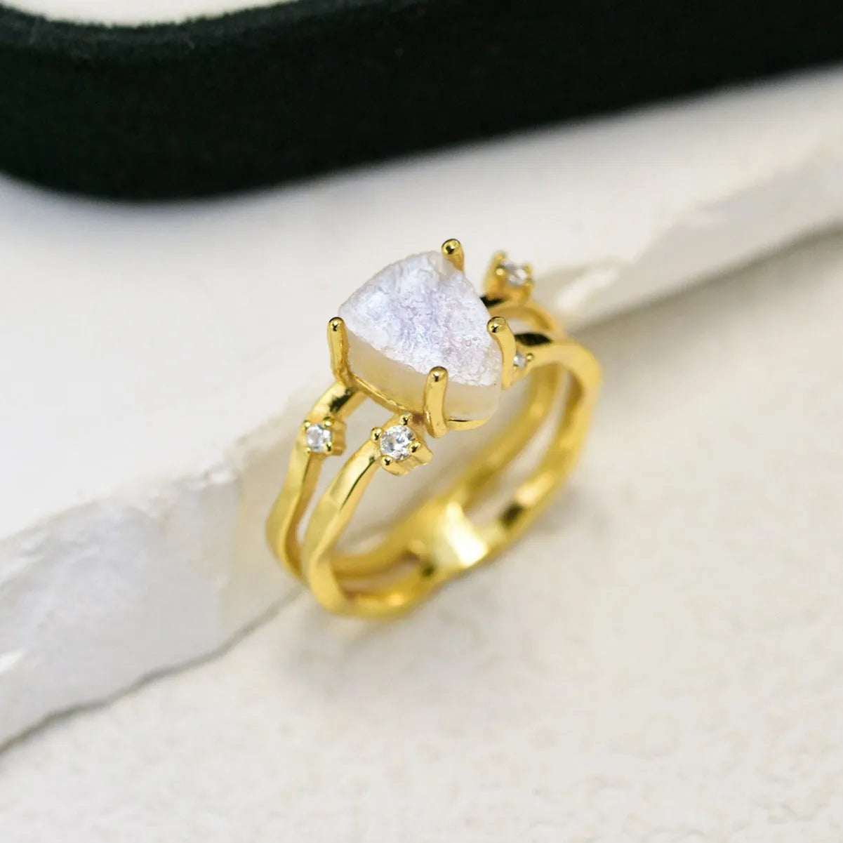 S925 silver geometric ring with irregular triangle design and moonstone, shown in rose gold finish.