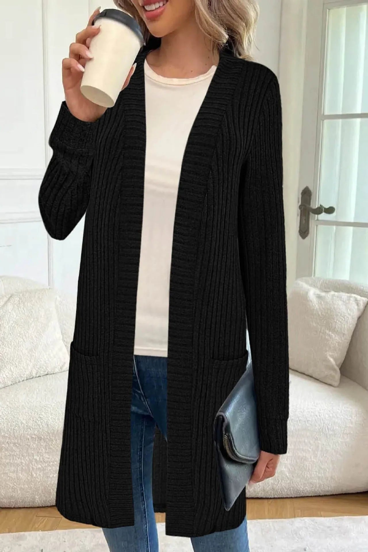 Long sleeve loose grey knitted cardigan jacket with pockets on a hanger