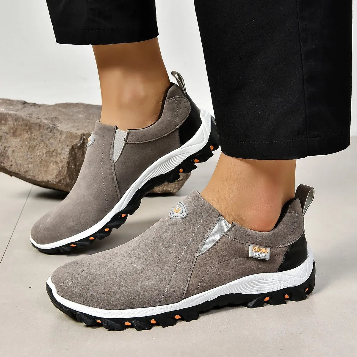 Men's thin grey overshoes with round toe, rubber sole, and shallow mouth design shown on a foot.