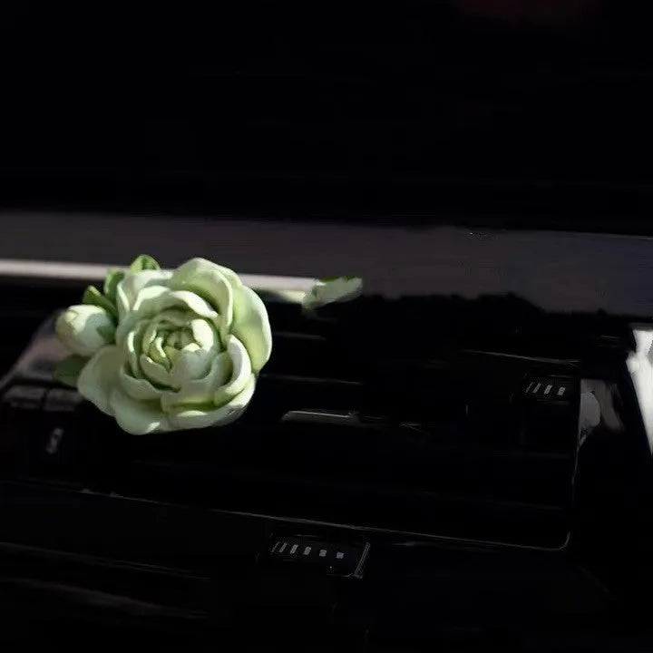 Solid gypsum car air vent perfume diffuser in off-white or green with 5ml jasmine oil bottle.
