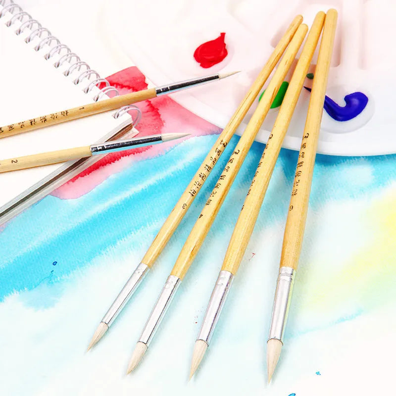 Six wooden handled artist brushes with pointed wool tips arranged as a complete set