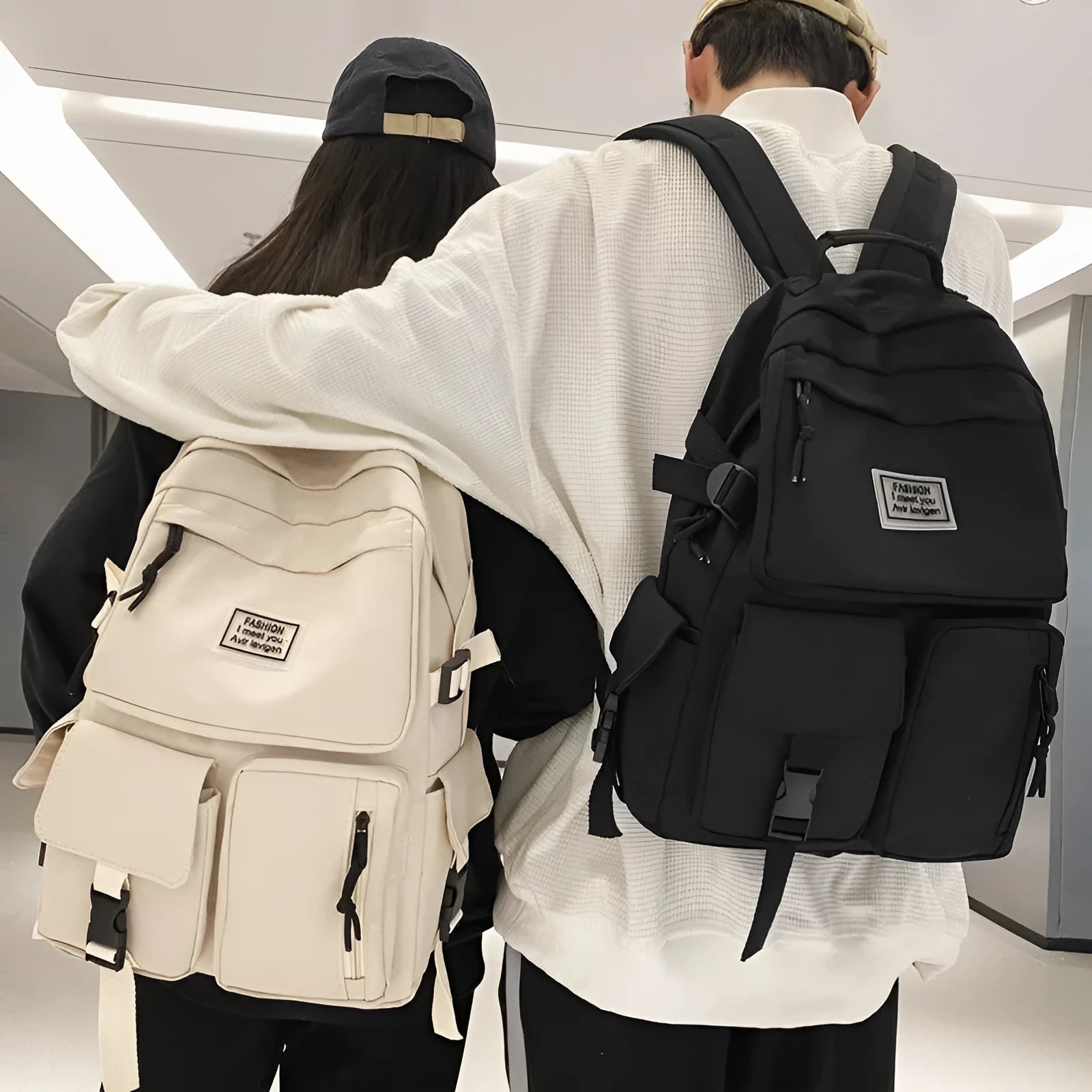 Black and white student nylon backpack with laptop compartment and outer pockets.