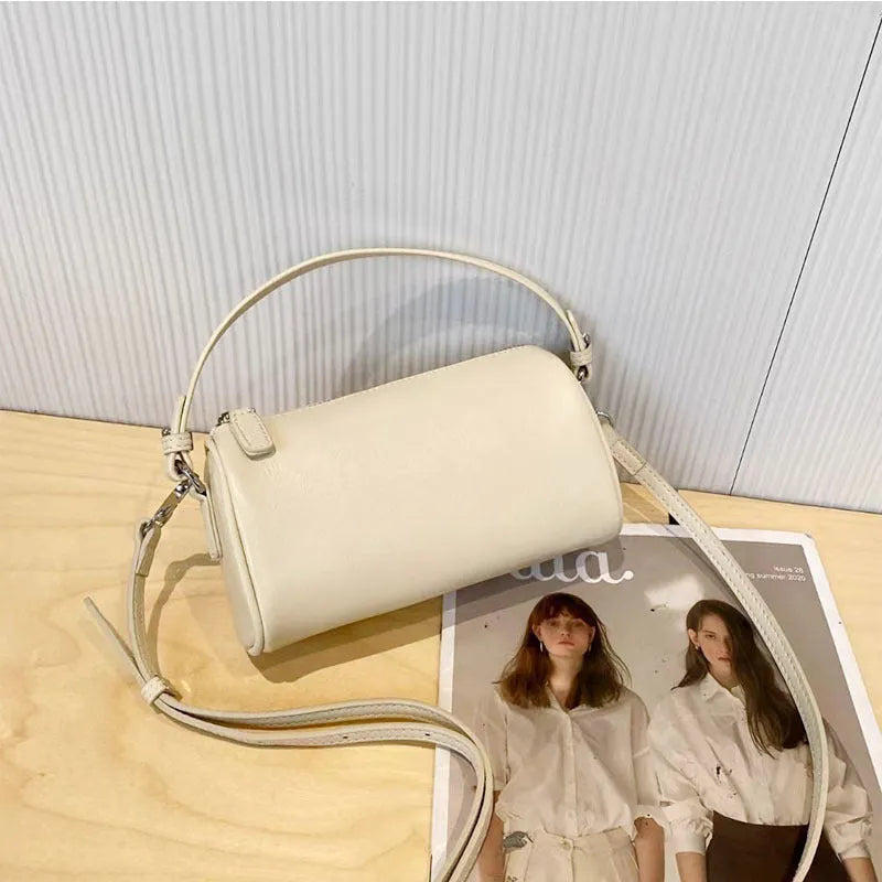 Genuine leather cylindrical crossbody phone bag in multiple colours with an adjustable strap.