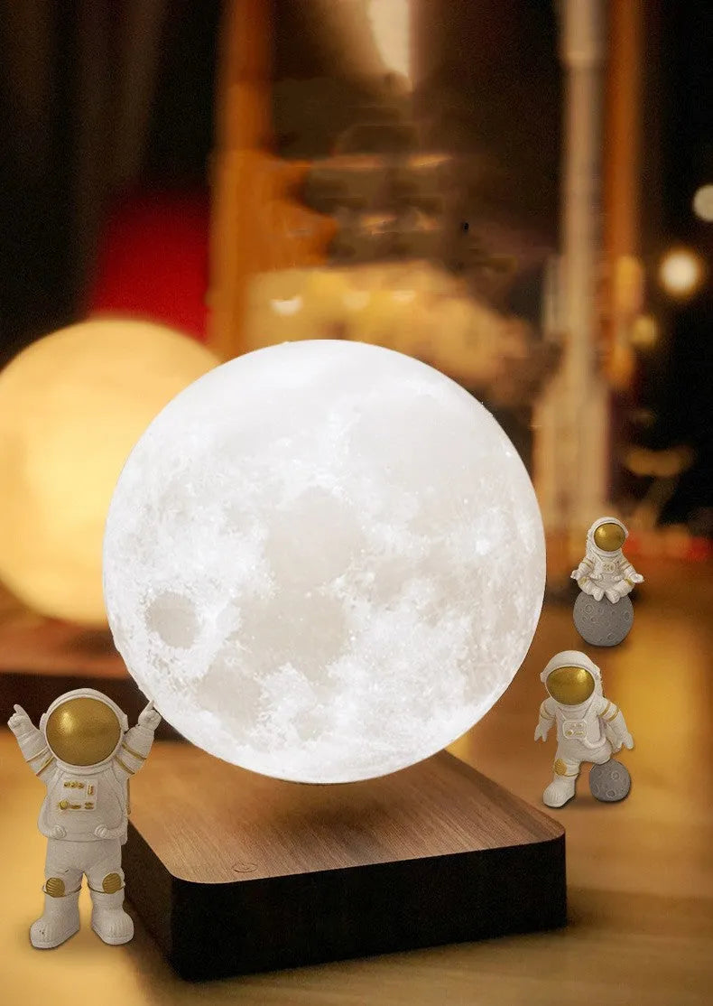 Maglev Earth and Moon night light floating above base with three astronaut figurines nearby.