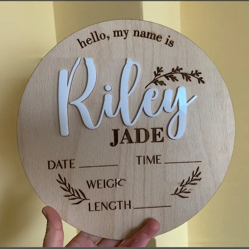 Square wooden baby birth information plaque with engraved details on a plywood base.