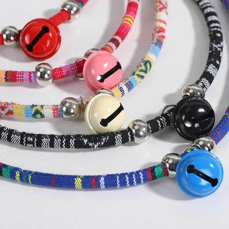 Coloured ethnic pattern adjustable pet collar for dog or cat with a small metal bell attached.