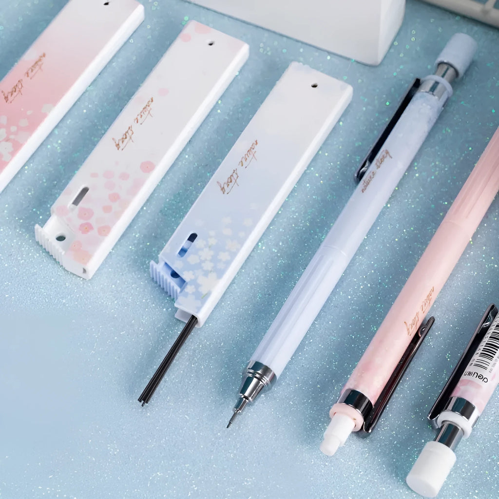 Cartoon automatic pencil set showing three 0.5mm pencils and HB refill boxes in mixed colours