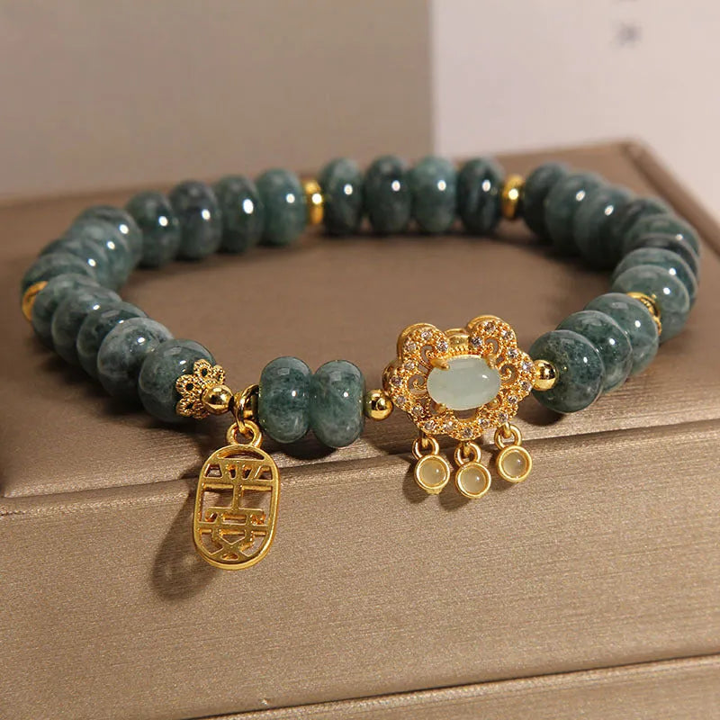 Natural emerald jade abacus bead safety lock style bracelet on women's wrist, alloy frame, green gemstone beads