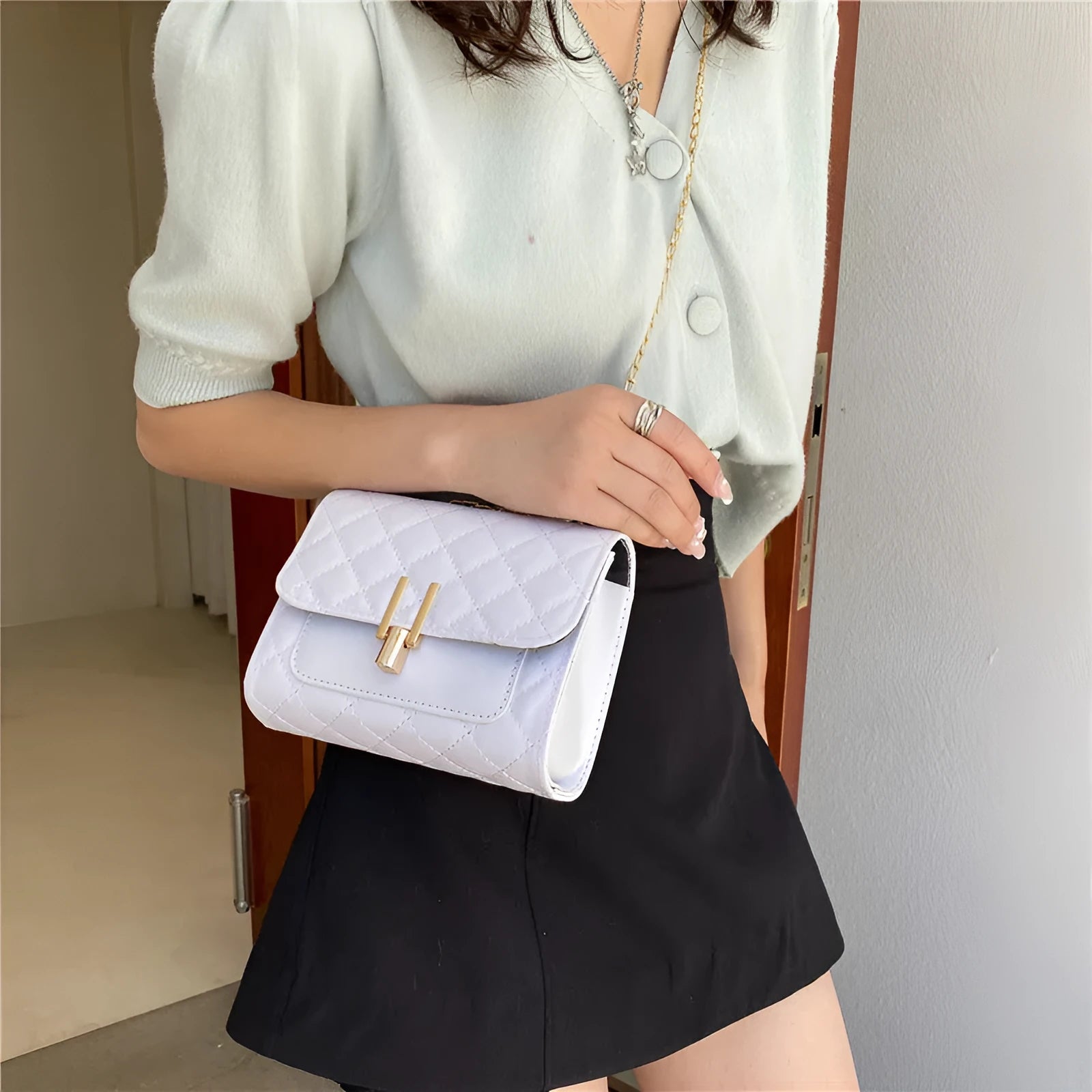 Women's diamond lattice chain crossbody bag in black, green or white with adjustable strap
