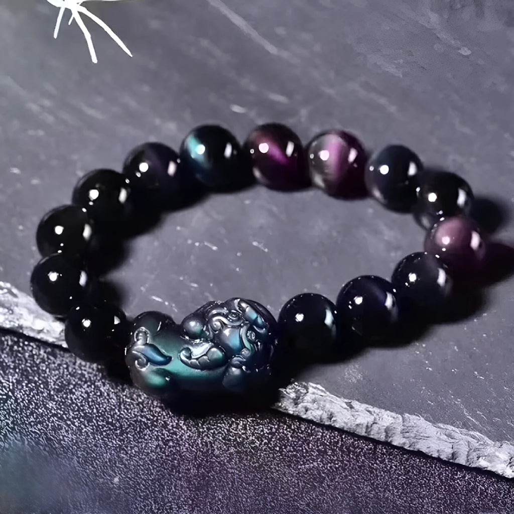 Natural ice colour eye obsidian crystal bead bracelet on a wrist, showing unisex design.
