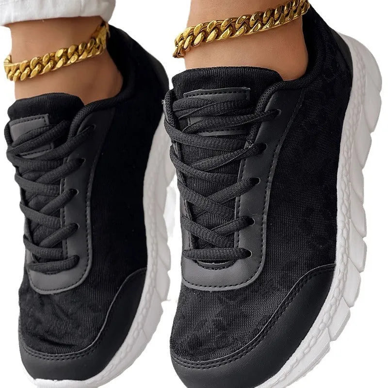 Women's casual canvas running shoes in white, black, blue, or pink with a flat heel and rounded toe.