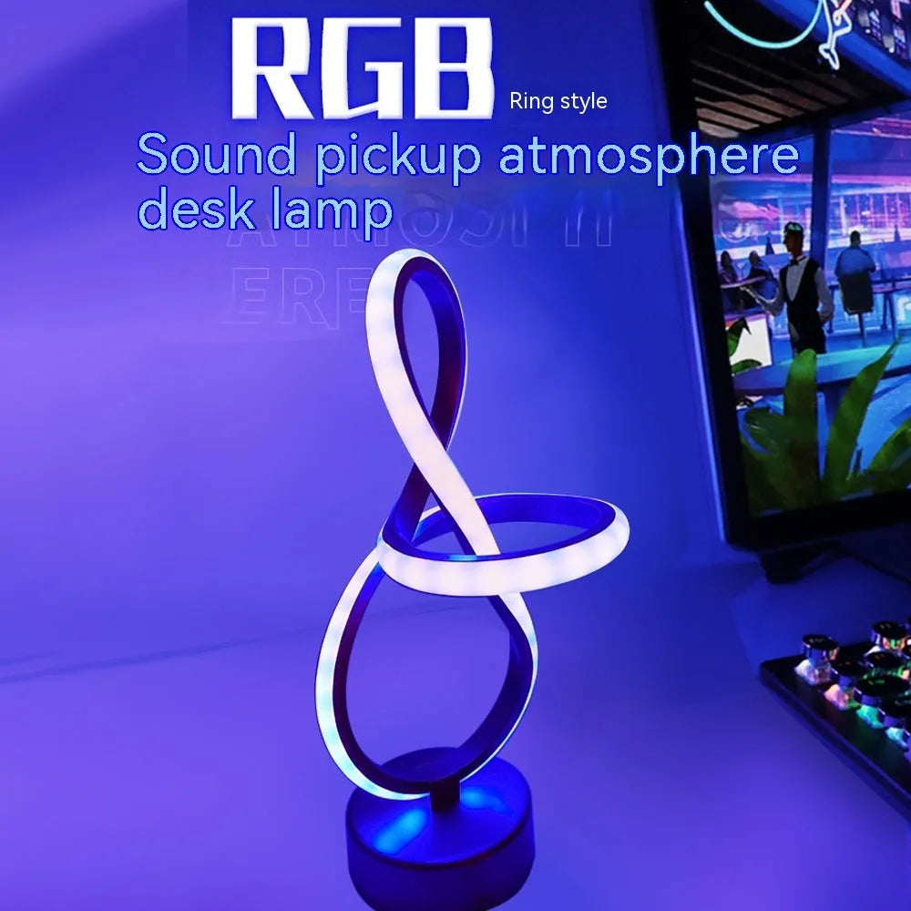 Black musical note shaped Bluetooth LED lamp with RGB colour changing lights on a table.