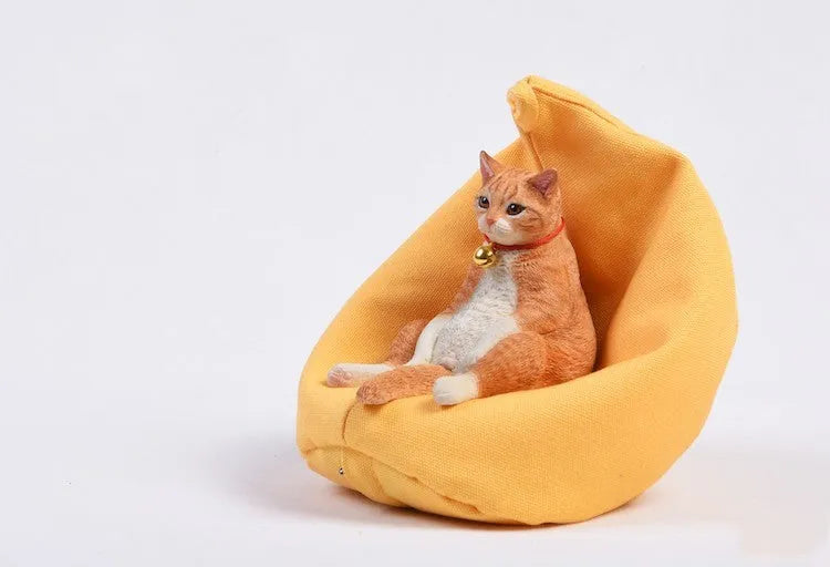 Lazy cat ornament with sofa, a 7.5cm high resin diorama for car dashboard or shelf.