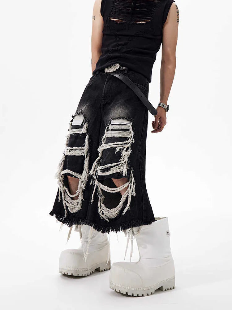 Black cropped wide-leg women's jeans with ripped patch detail on the knee.