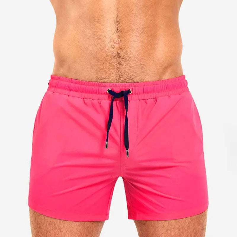 Men's solid colour polyester shorts with mesh lining for swimming and sports.