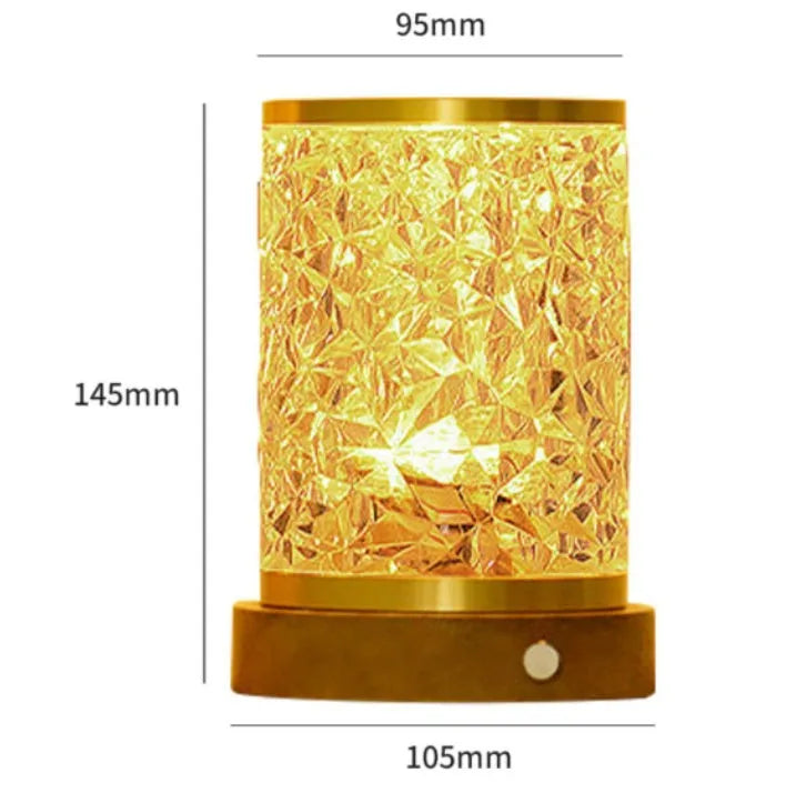 Small rotating water ripple night light with acrylic shade on a solid wood base.