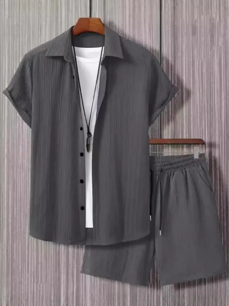 Men's black and white Jacquard print short sleeve suit with matching shorts on a hanger.