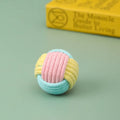 Handmade blue powder and green cotton plush ball cat toy for play and teeth grinding.