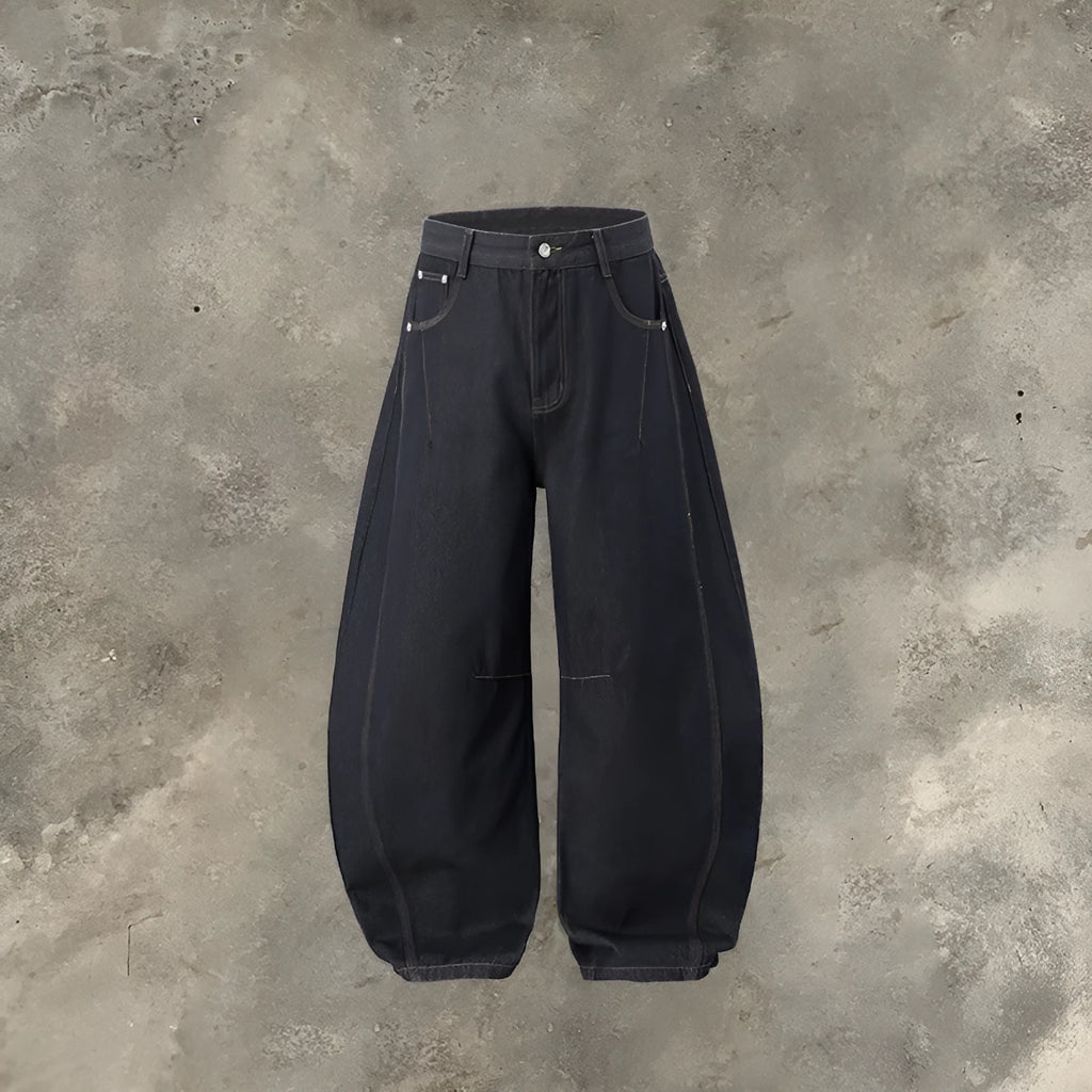 Men's wide leg cotton denim trousers in original cow colour, shown laid flat.
