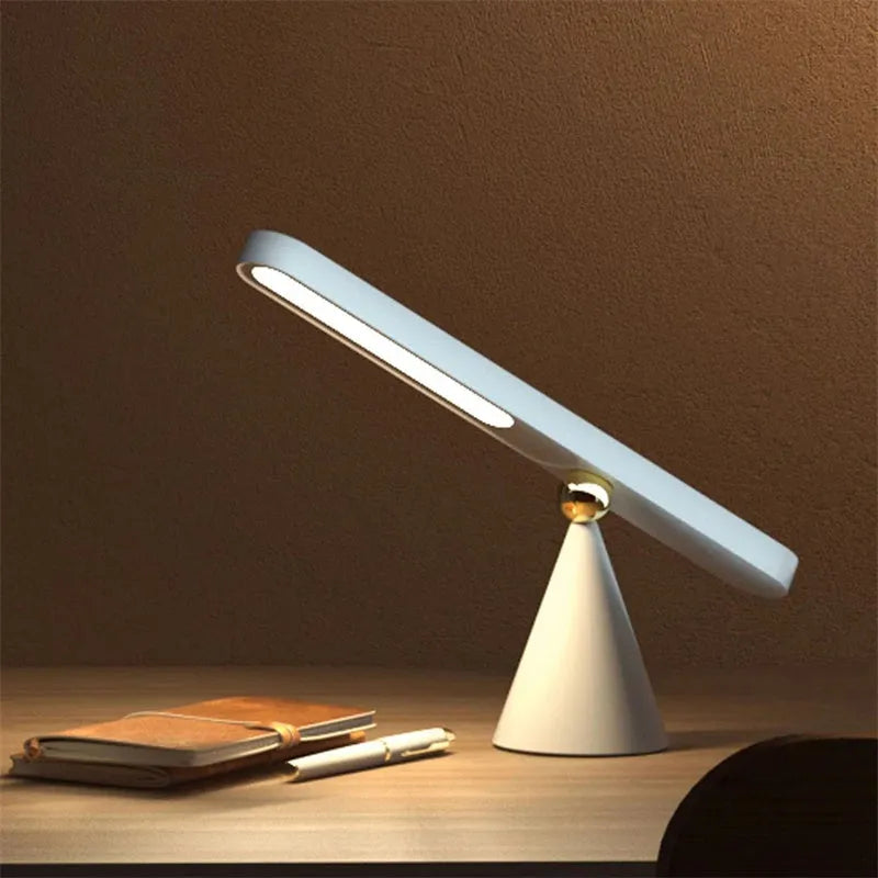 Geometric creative desk lamp with magnetic base shown in white on a desk.