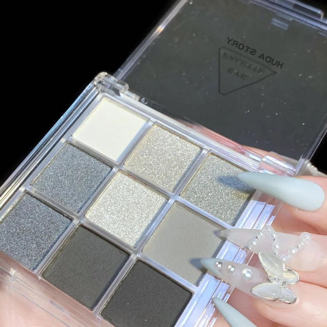 Smoked nine-colour eyeshadow palette showing shades including white, silver, black, and iron grey