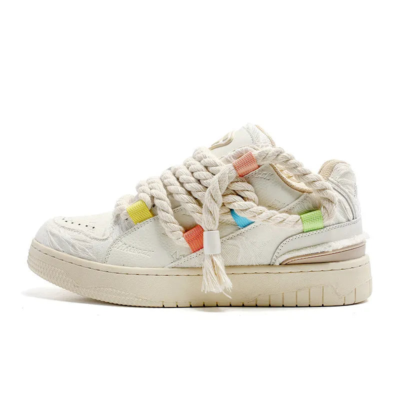 Old Damage brand creamy white retro skate shoes with low platform heel and lace-up front.