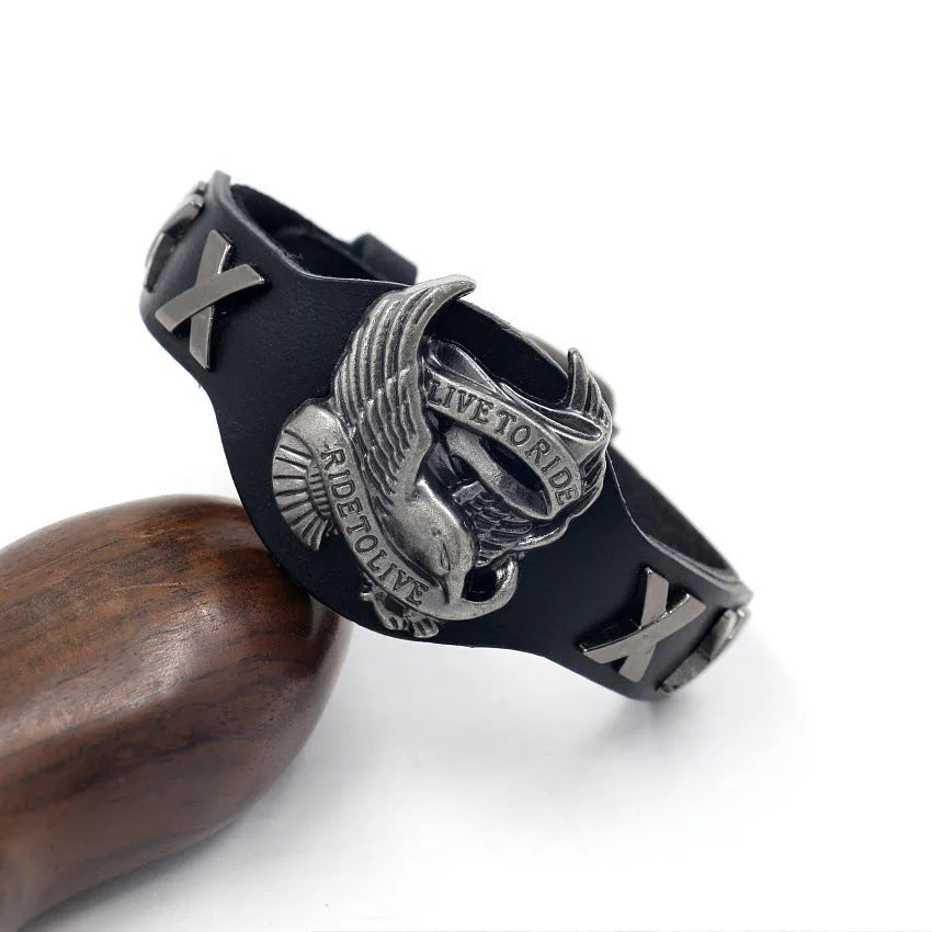 Black geometric leather bracelet with alloy eagle watch-button closure showing varying width from 1.7cm to 3.8cm