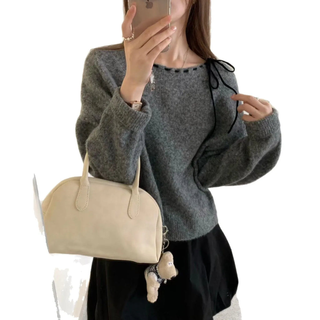 Women's loose-fitting grey knitwear pullover top with long sleeves on a hanger