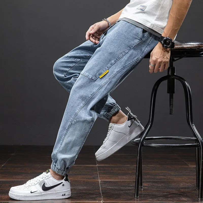 Man wearing loose fit straight leg cargo jeans in blue, showcasing the Korean style and micro-elastic cotton fabric.
