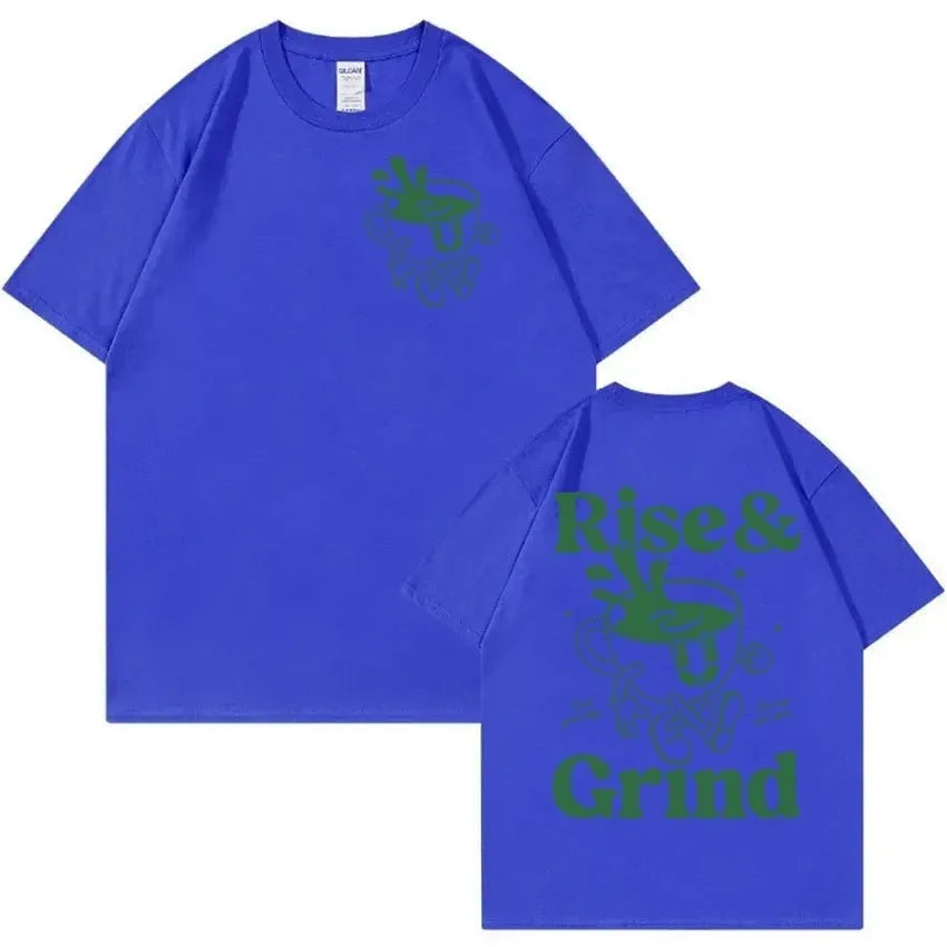 Front view of a loose-fit linen T-shirt featuring a printed 'Rise And Grind Green Coffee' cartoon design in black on a light-coloured fabric.