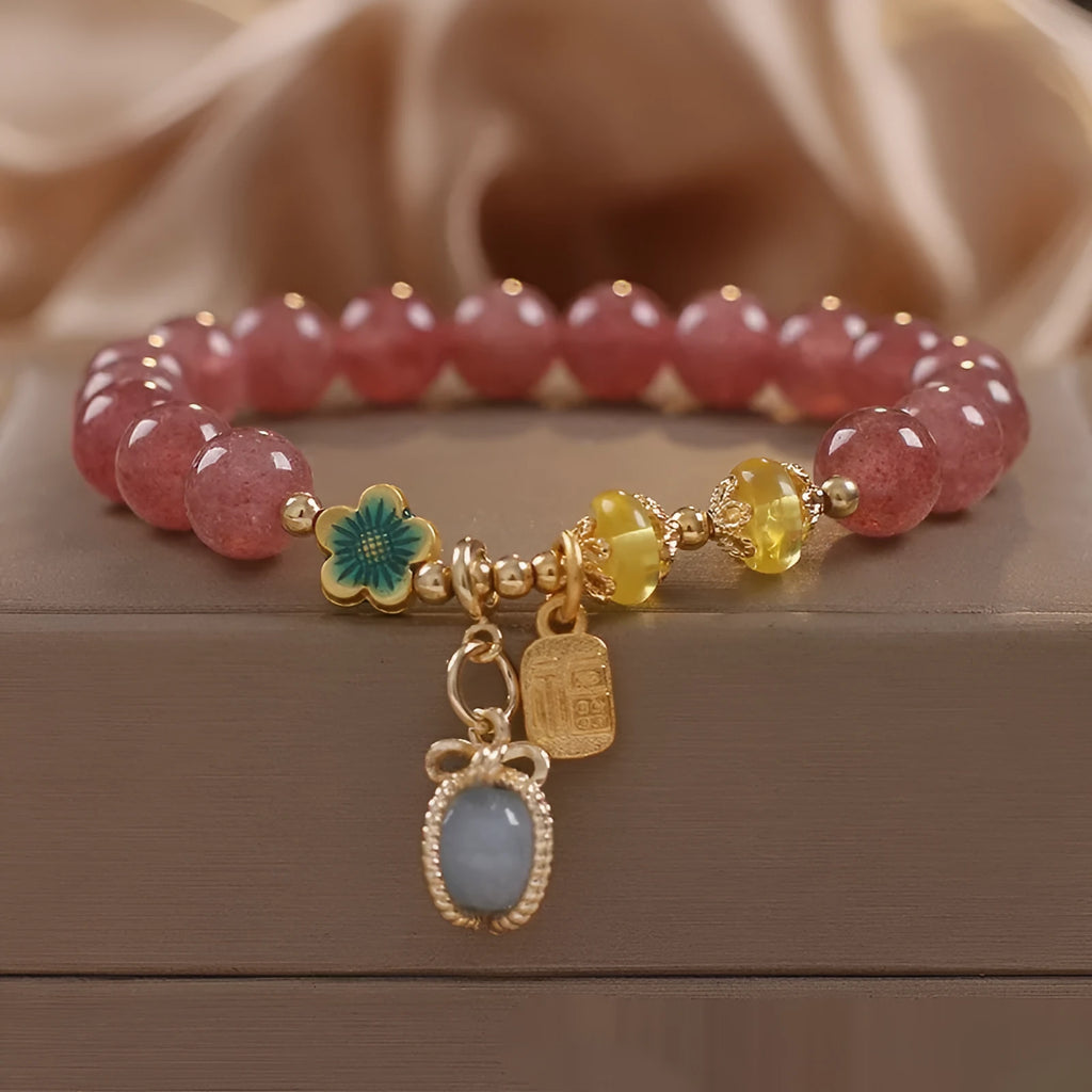Natural strawberry quartz beaded bracelet red alloy with rhinestone details on white background