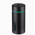 Black A6 aluminium alloy portable car humidifier and essential oil diffuser with USB cable on a desk.